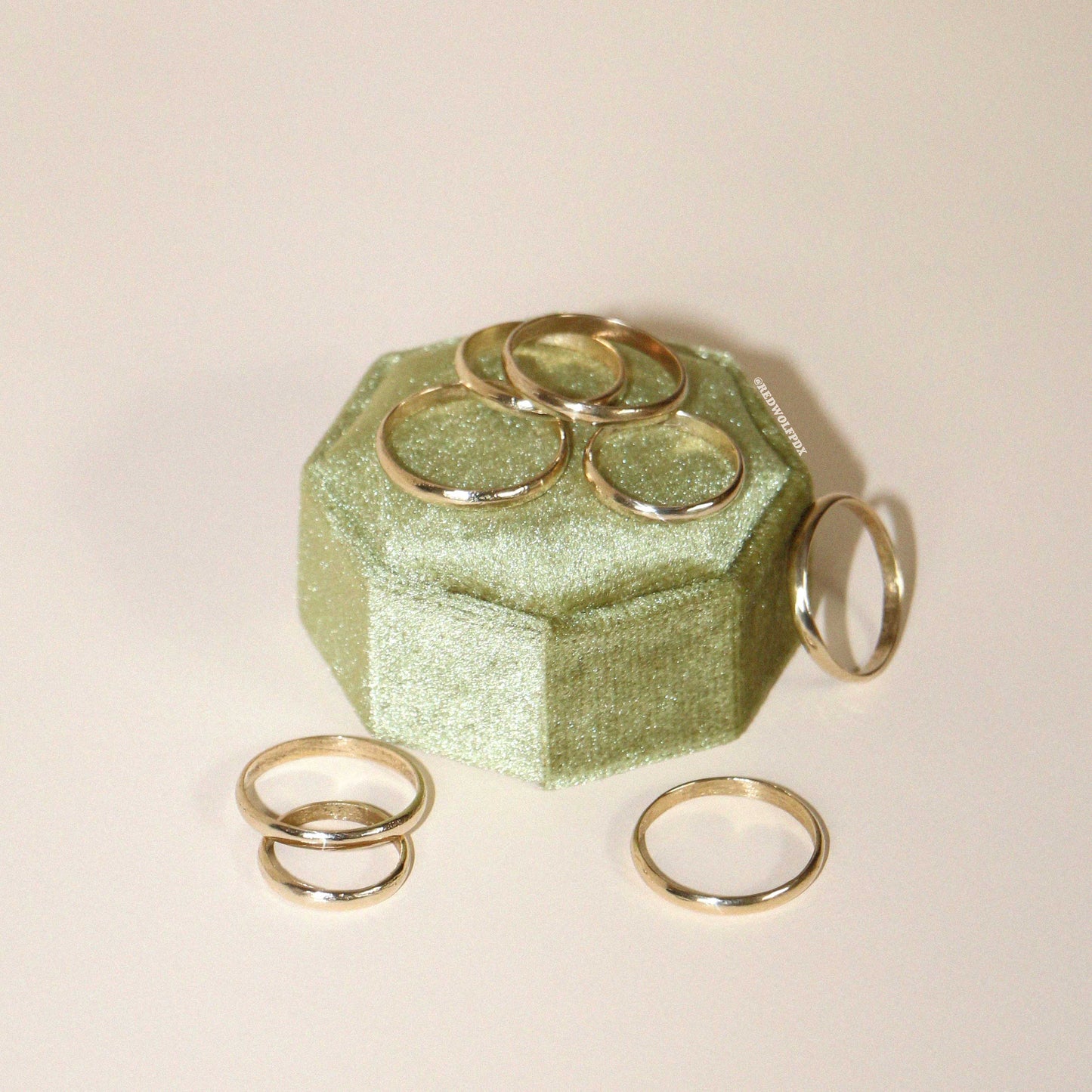 A collection of rings displayed on a green textured surface