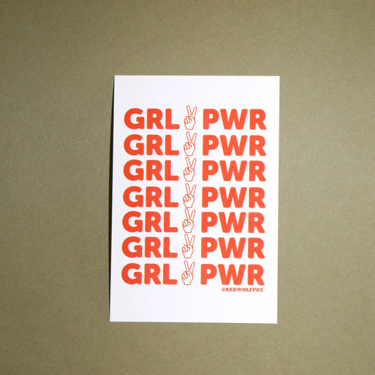 red orange text 'GRL PWR' graphic on white rectangle sticker background on a vintage green backdrop