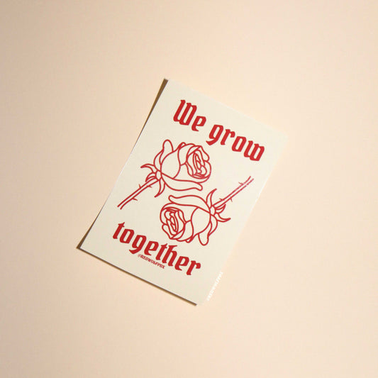 beige sticker with text 'We grow together  in gothic font with 2 red roses illustration graphic sticker on beige 
backdrop