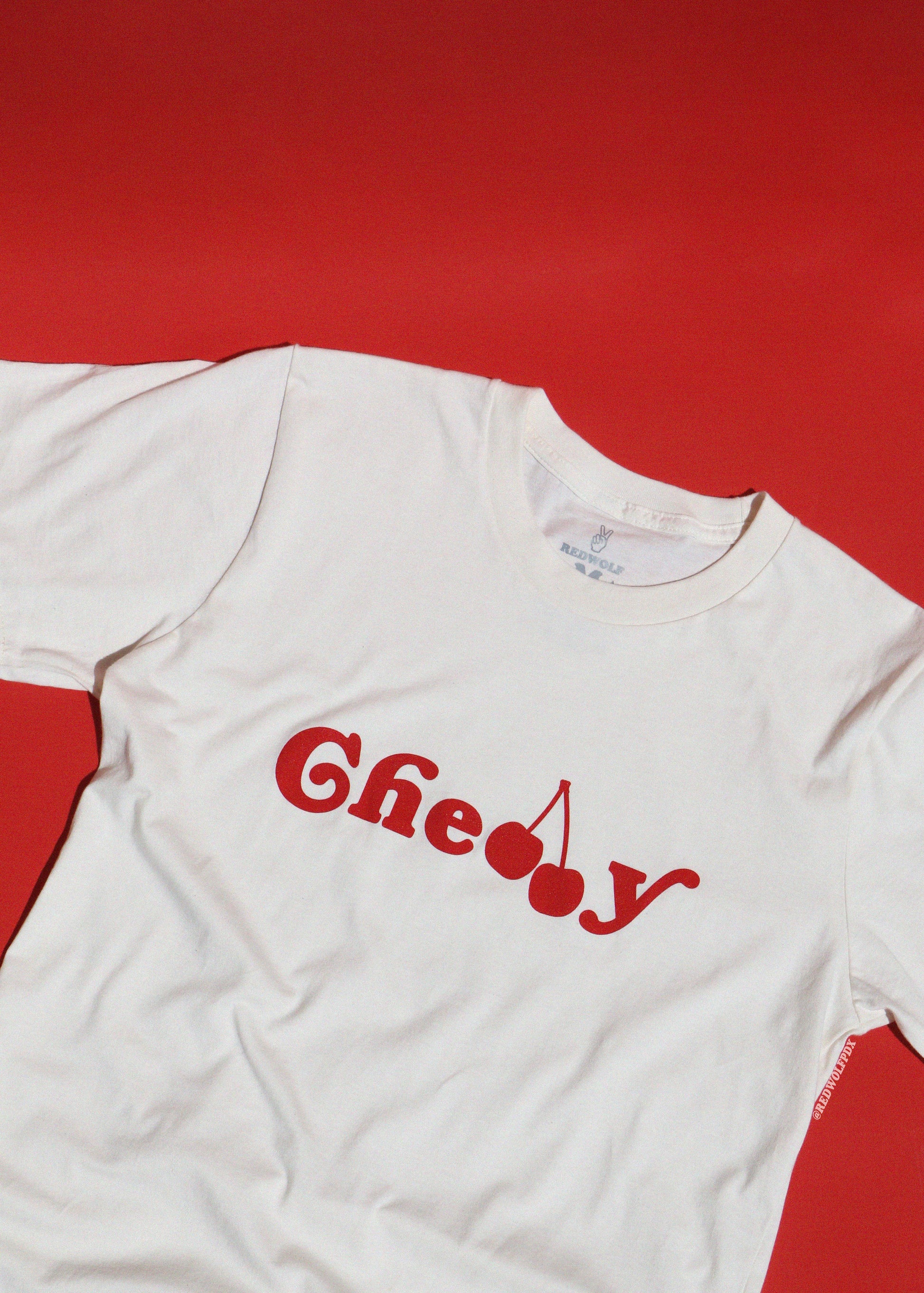 White t-shirt with red text 'Cherry' on a red background