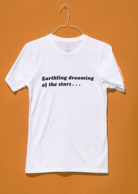 White t-shirt with text on a hanger against an orange background