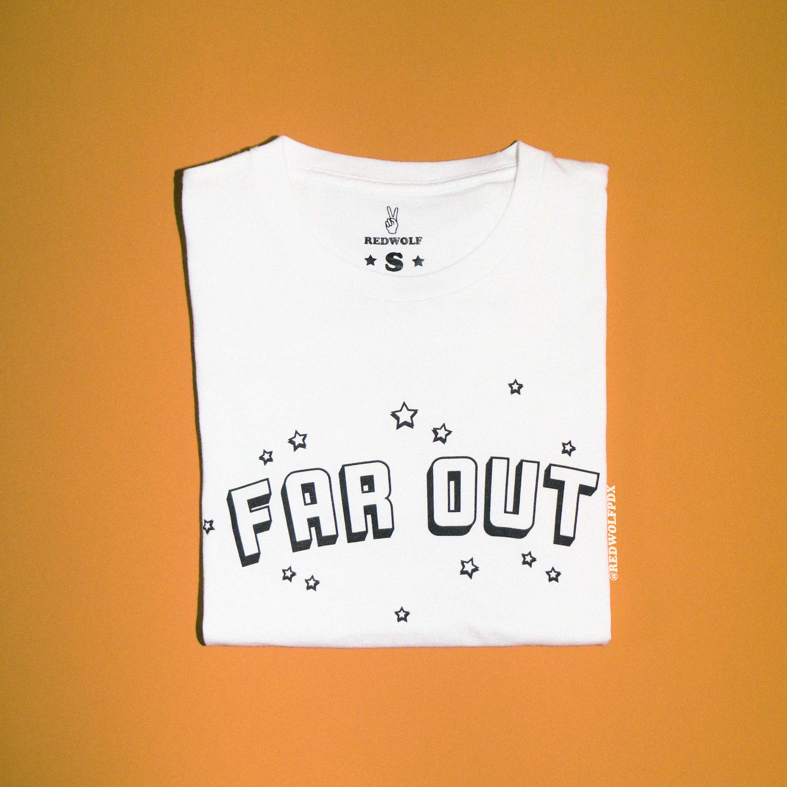 Folded white graphic tee with text 'FAR OUT' in black with star illustrations graphic on front against a vintage orange background