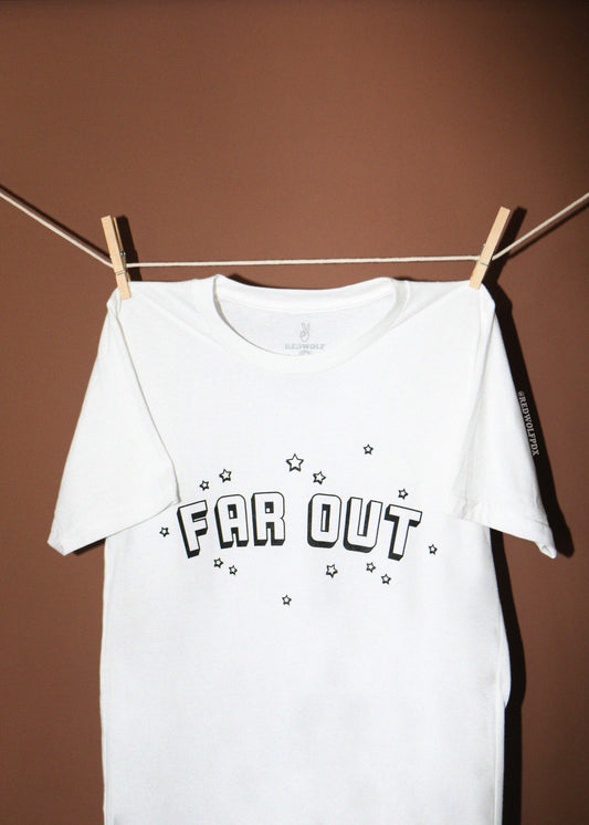 A white short-sleeve t-shirt with 'FAR OUT' and stars printed in black on the front, hanging from a clothesline with wooden clothespins against a solid brown background.