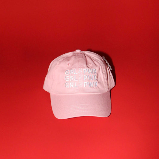 Pink cap with 'GRL PWR' text on a red background