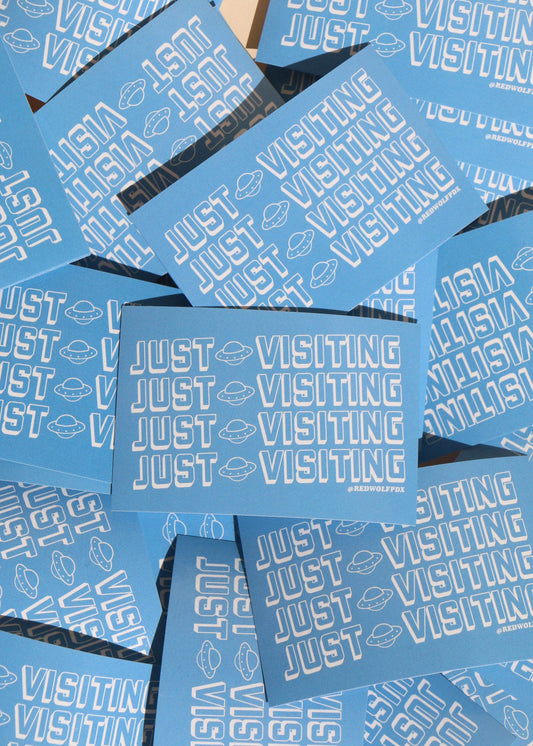 Blue stickers with 'JUST VISITING' text  on a blue background