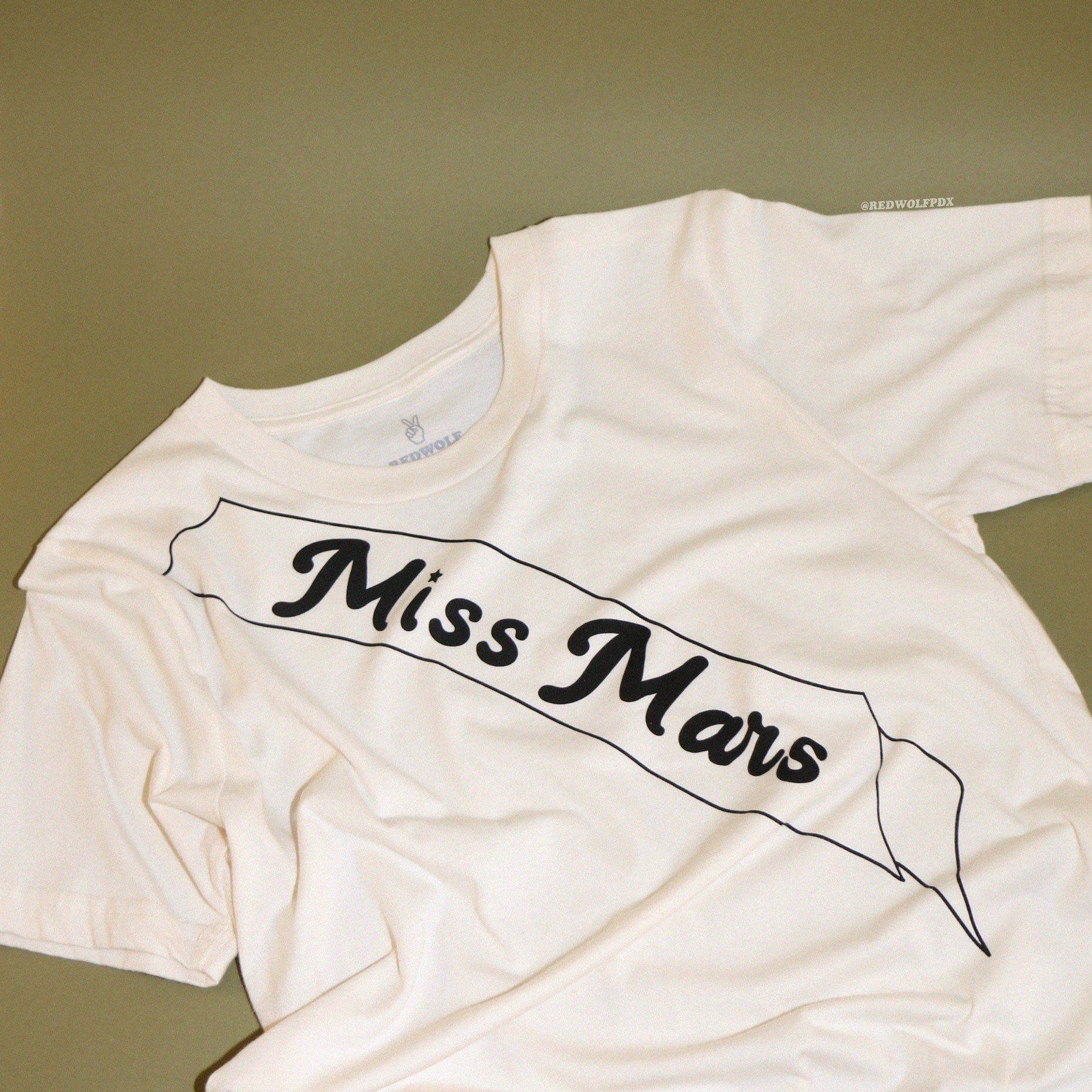 miss mars graphic tee with green backdrop