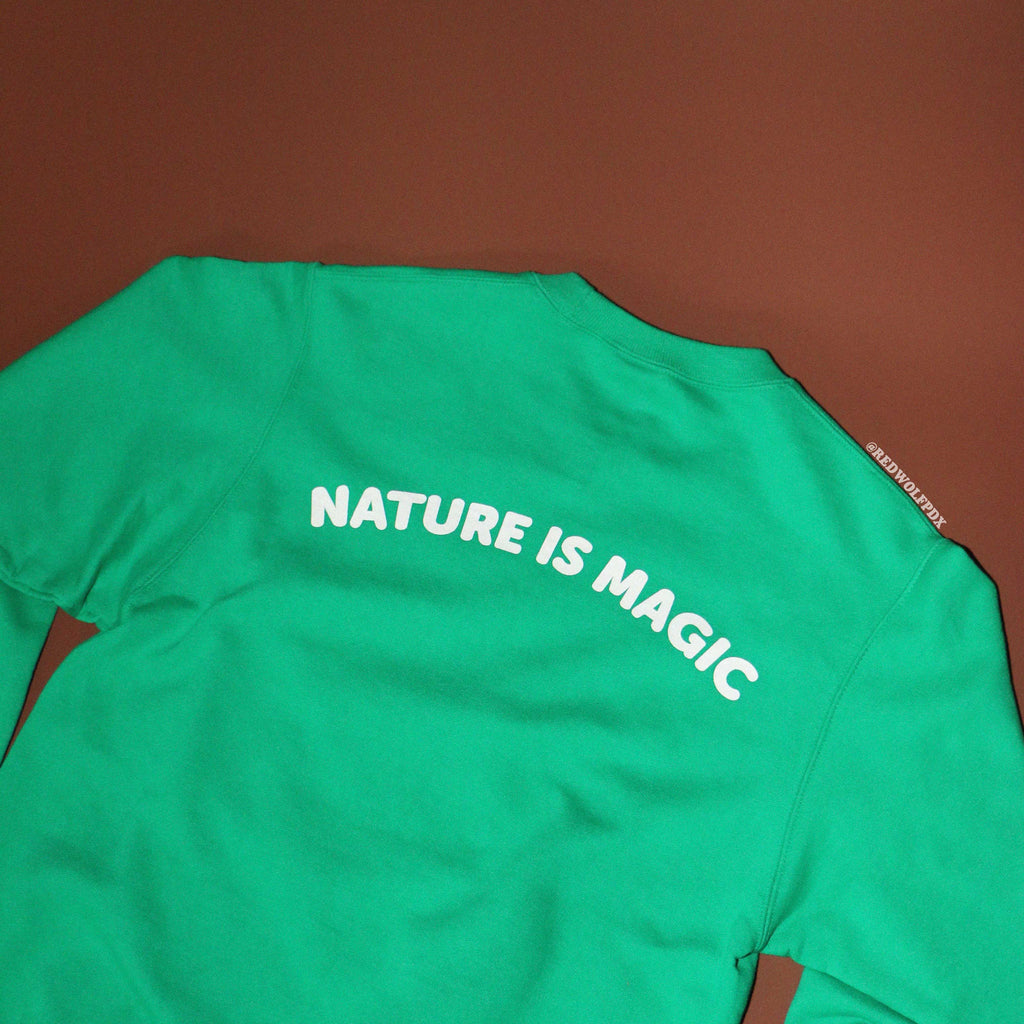 Green shirt with 'NATURE IS MAGIC' text on a brown background