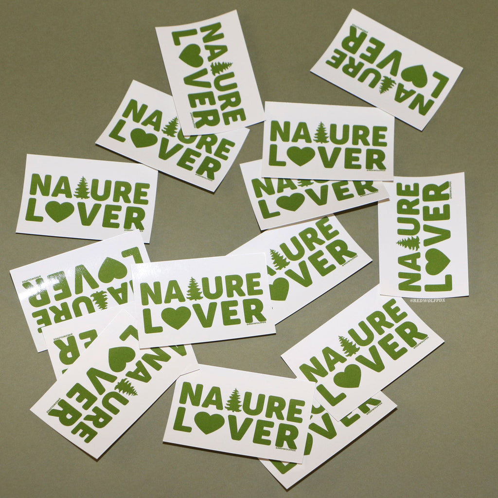 Rectangle beige stickers with text 'NATURE LOVER' in green ink scattered on a green backdrop