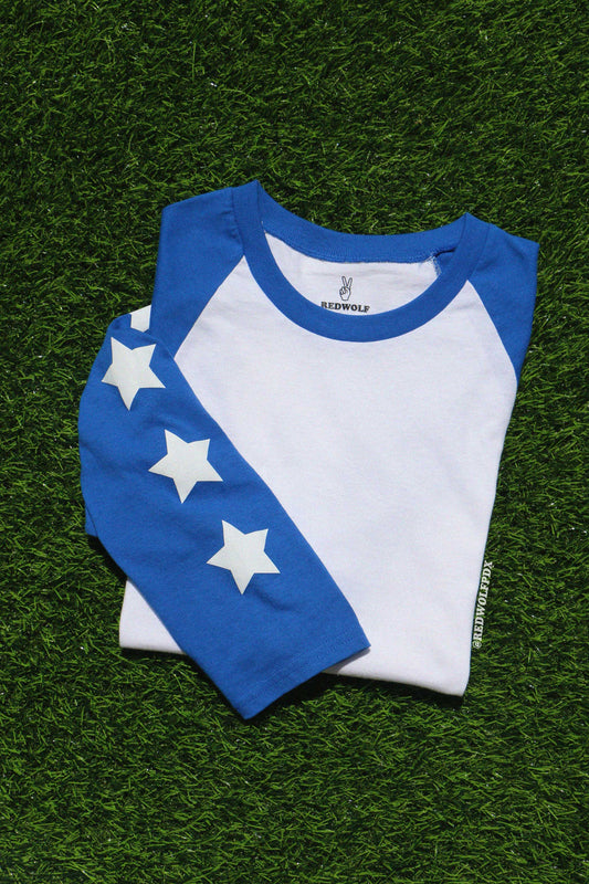 White and blue baseball shirt with star patterns on a green grass-like surface