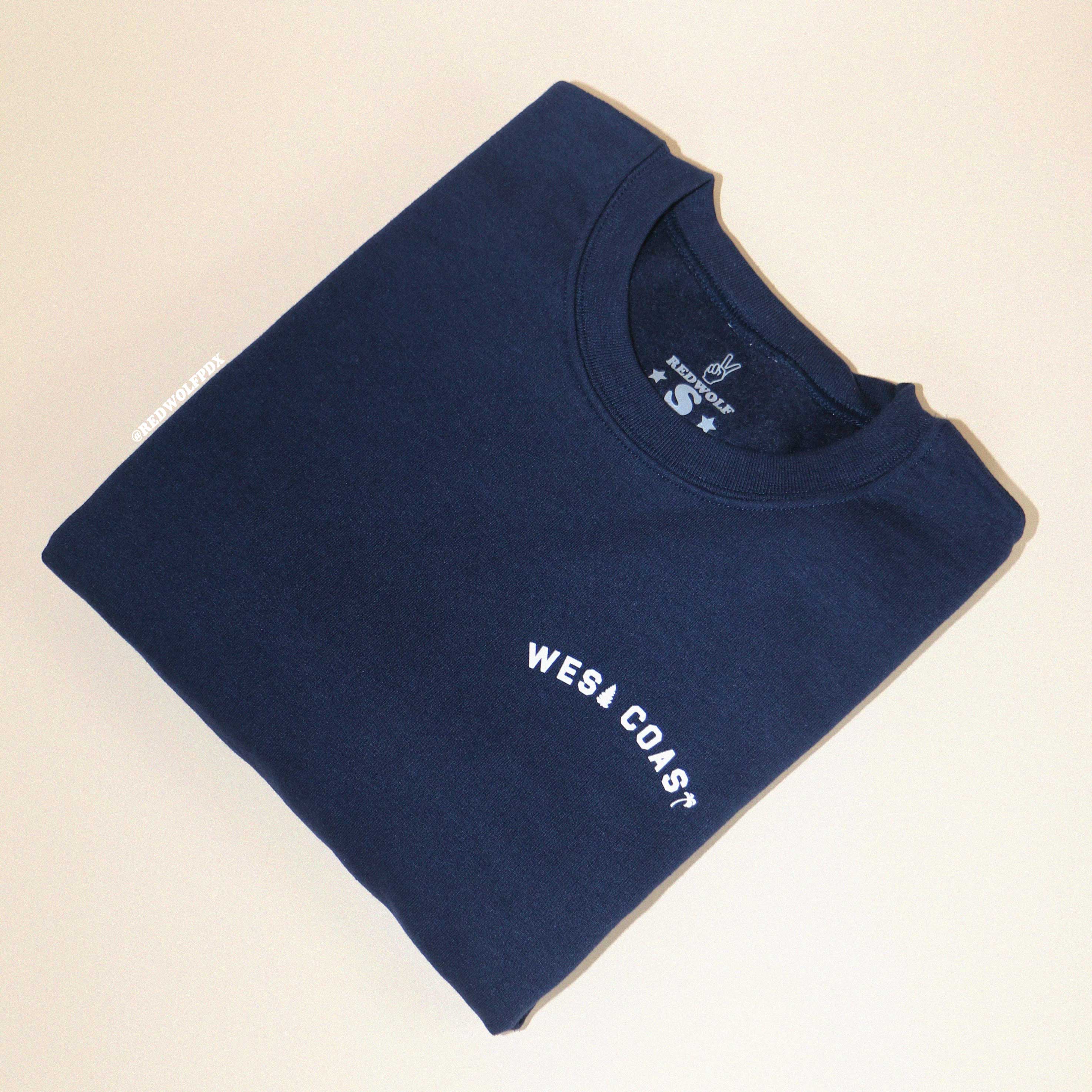 Navy blue sweatshirt with the text 'WEST COAST' printed in white.