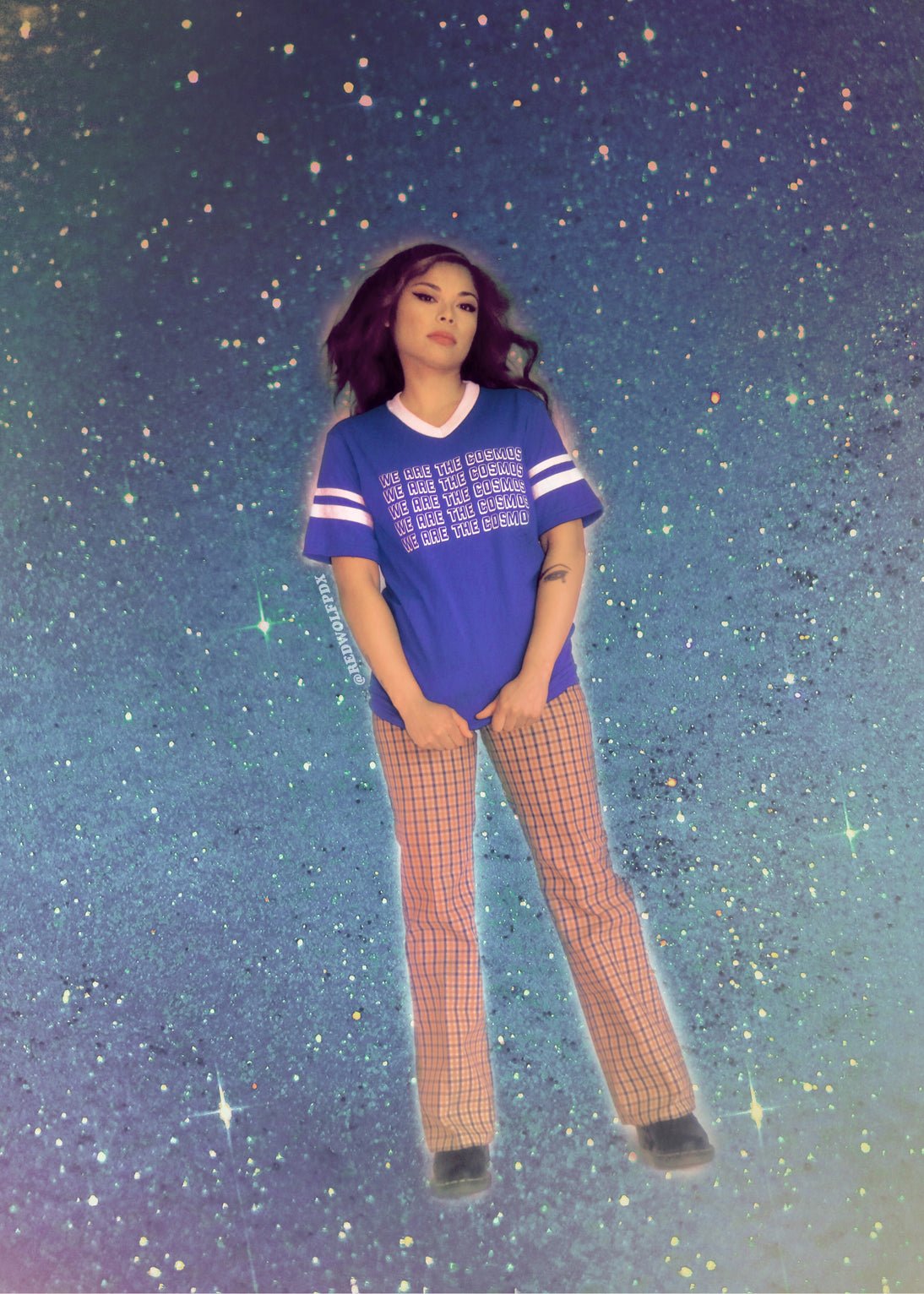Blue t-shirt with 'We Are The Cosmos' text being worn against a space background