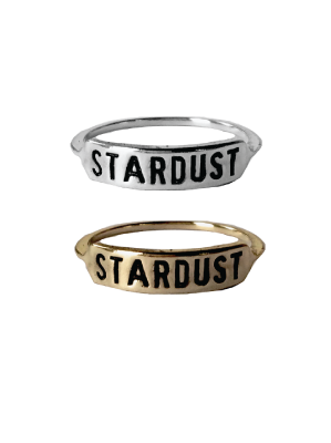 a sterling silver ring and brass ring both engraved with text 'STARDUST' across them on a white background