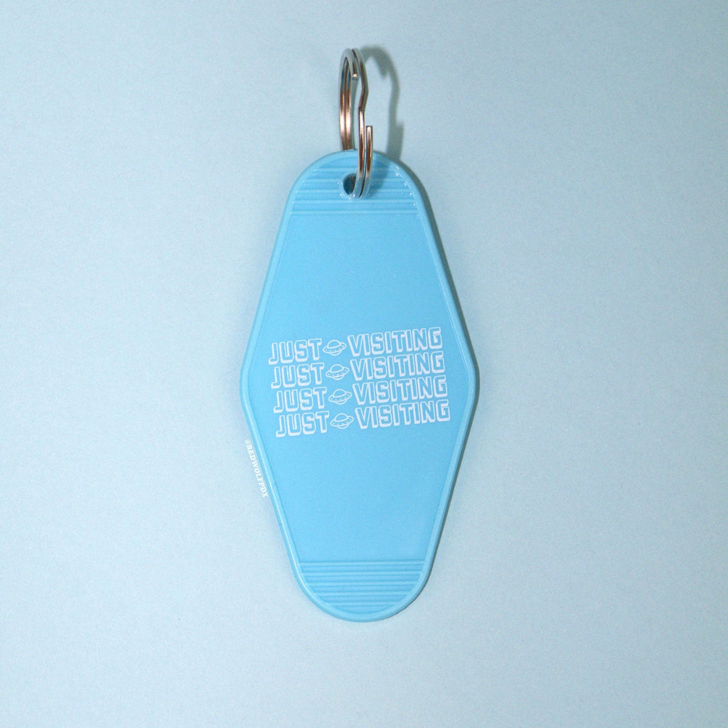 Baby blue retro motel style keychain on a blue background
