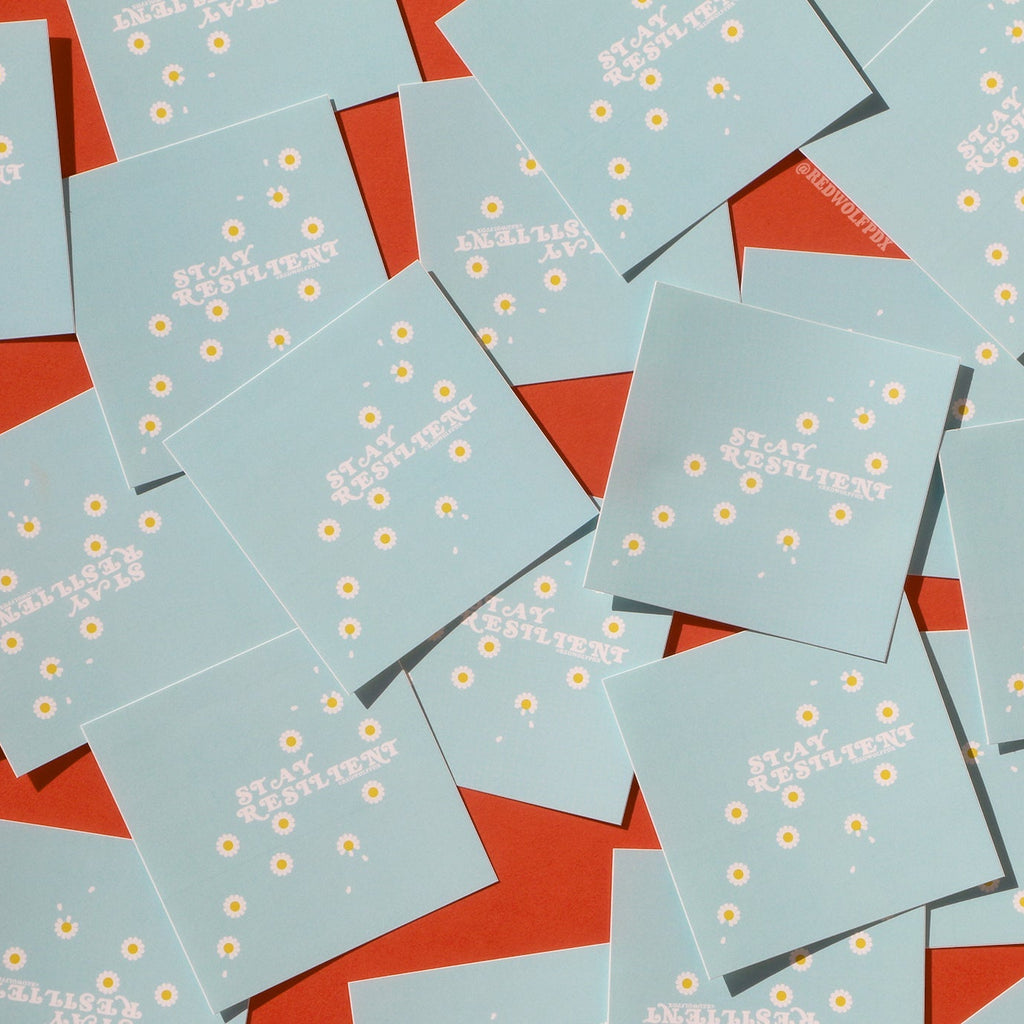 scattered baby blue square stickers with the text 'STAY RESILIENT' on them with daisy illustrations on red backdrop